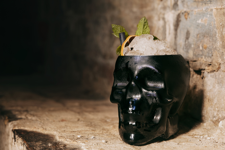 Close up of cocktail in black skull shaped glass