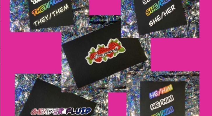 Stickers that say Genderfluid, She/Her, He/Him and They/Them