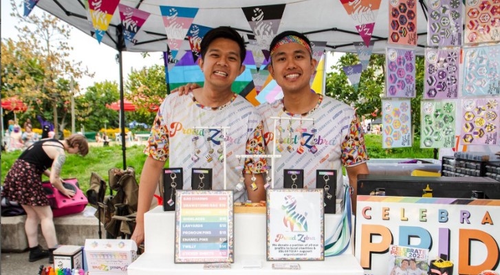 The founders of Proud Zebra in front of their booth at a pride event 