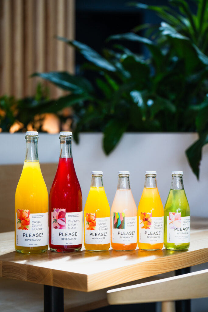 Colourful bottled cocktails sitting atop a table.