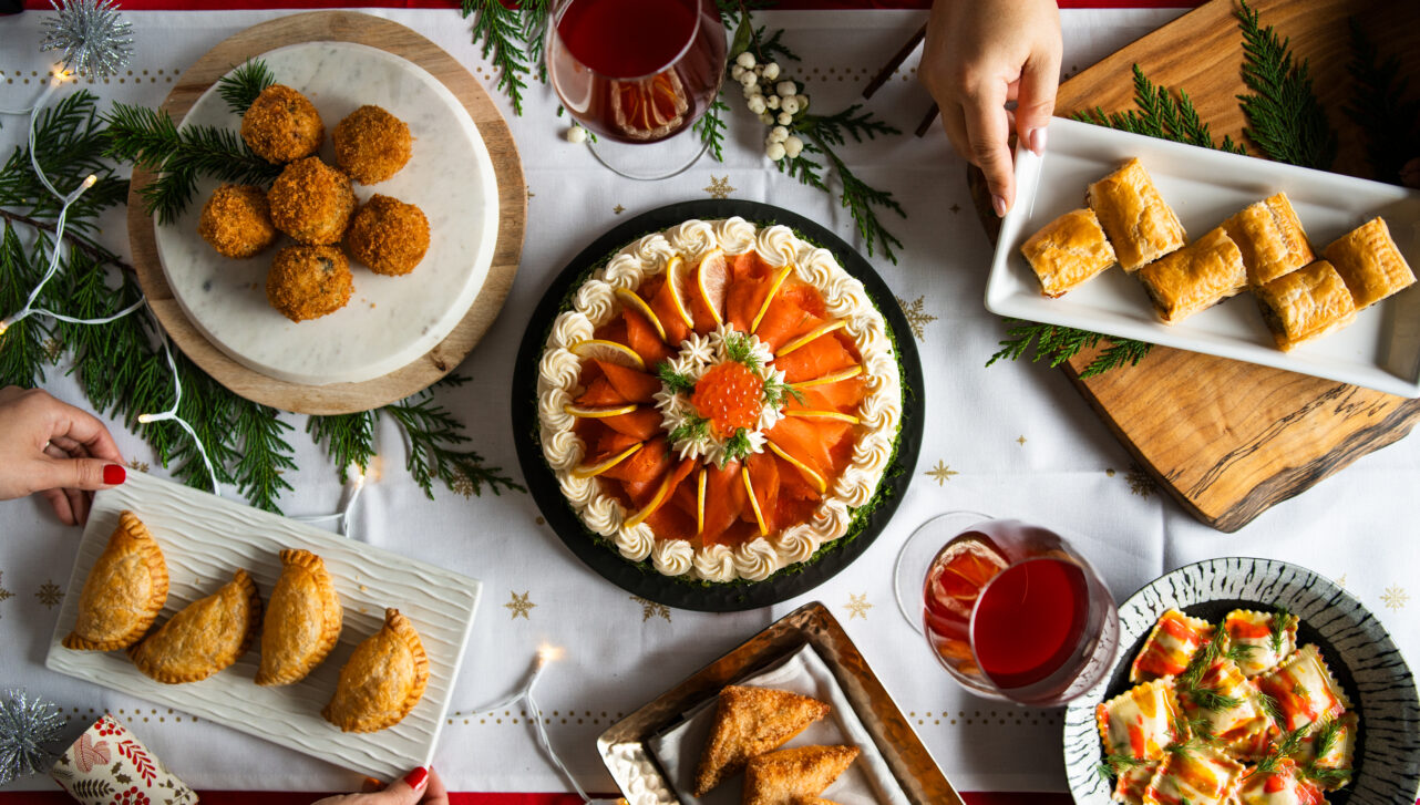 A table filled with fish-based appetizers and dishes on plates.