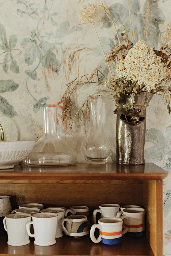 mugs and glassware on a vintage buffet