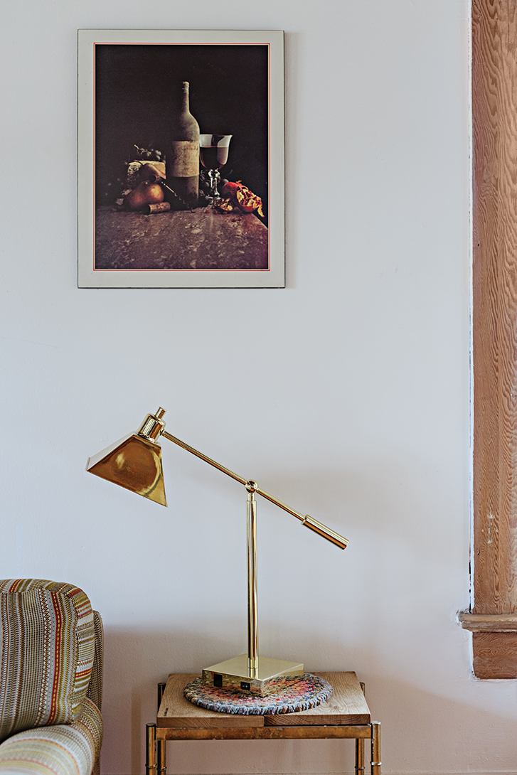 a brass lamp on a side table