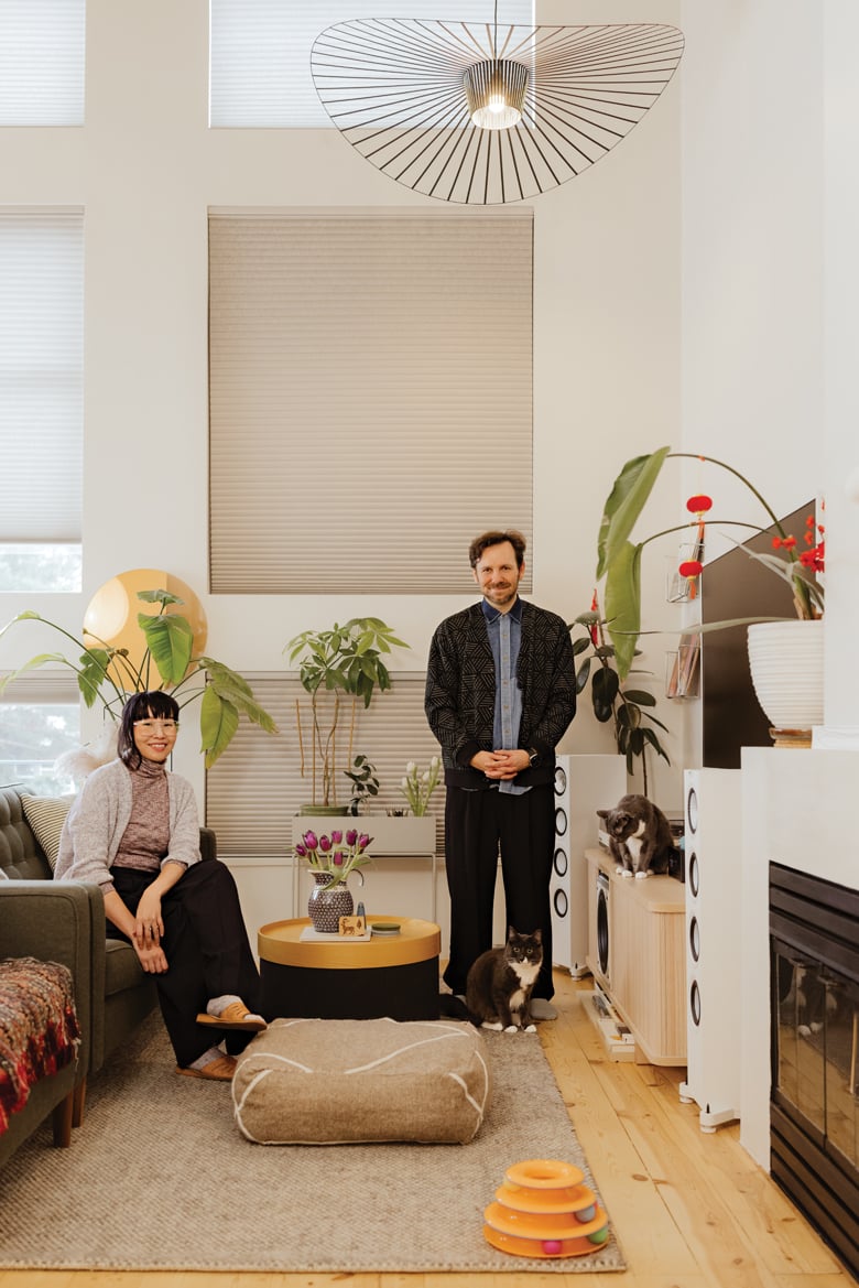Tran and Wagner with their beloved cats in their Mount Pleasant loft. Photo by Tanya Goehring. 