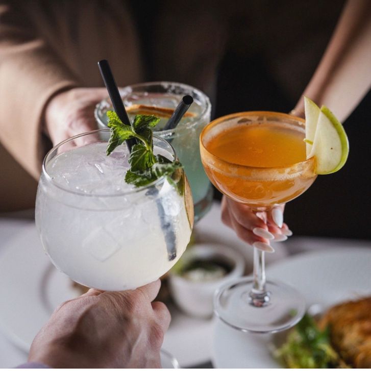 Three cocktails cheersing together