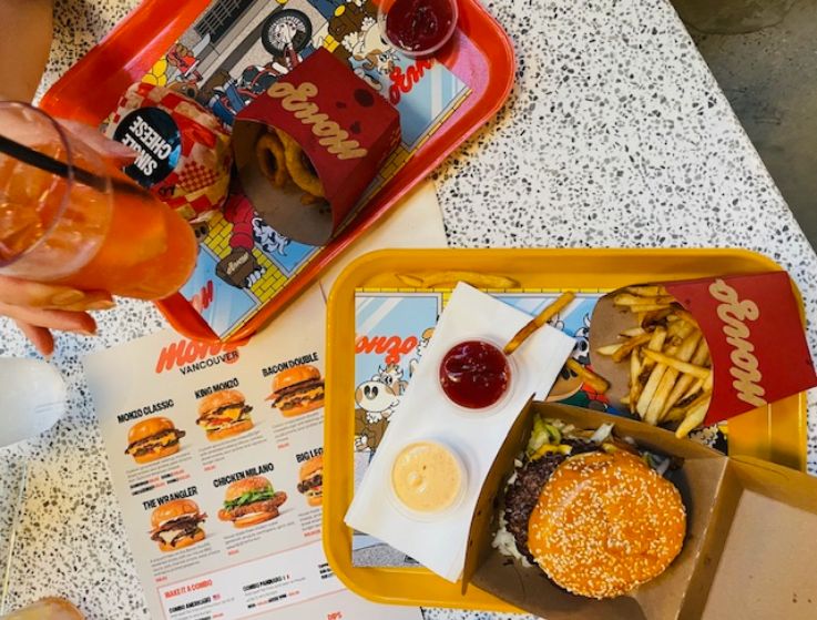 Two trays of burgers and fries. 