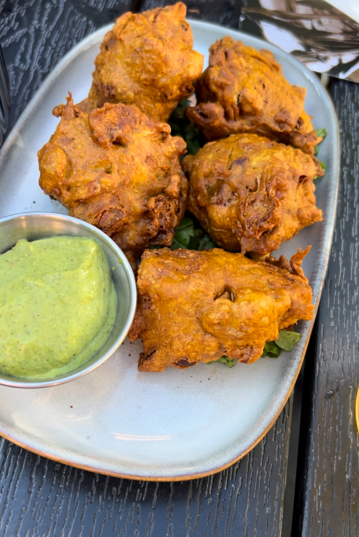 a plate of pakoras and chutney