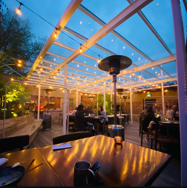 a patio lit up by string lights