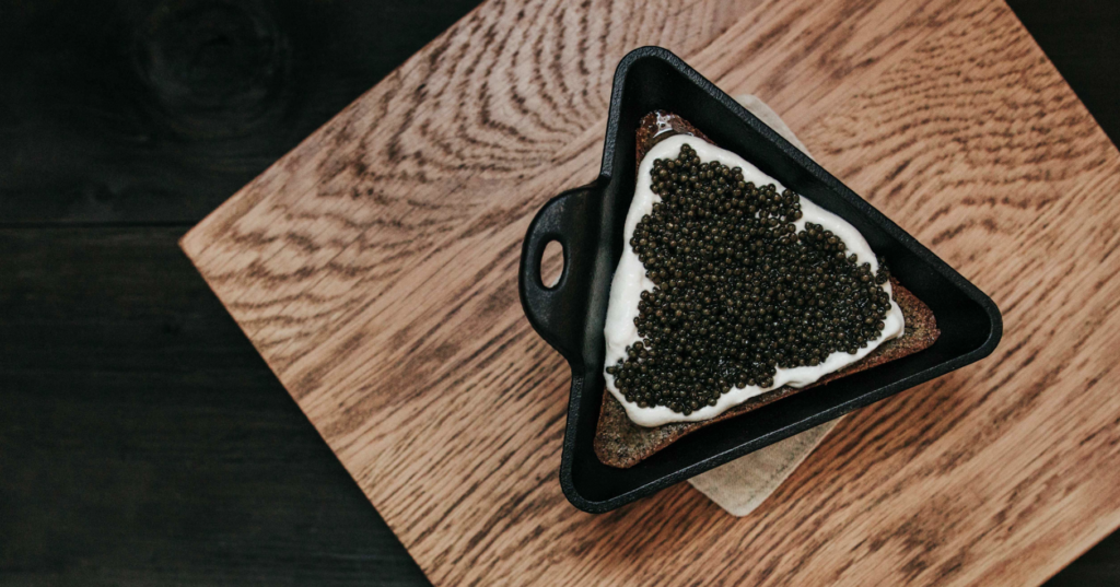 Caviar and creme fraiche in a triangle dish.