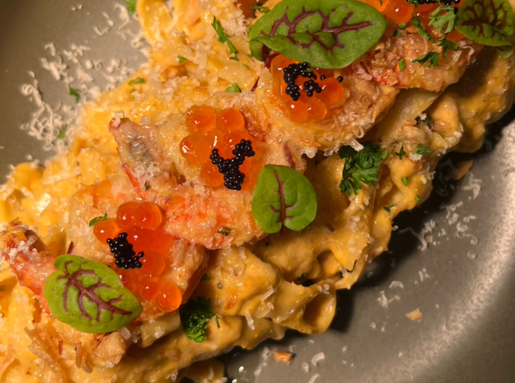 Creamy uni pasta with microgreens and roe on top. 