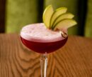 Close up of a red cocktail with pear