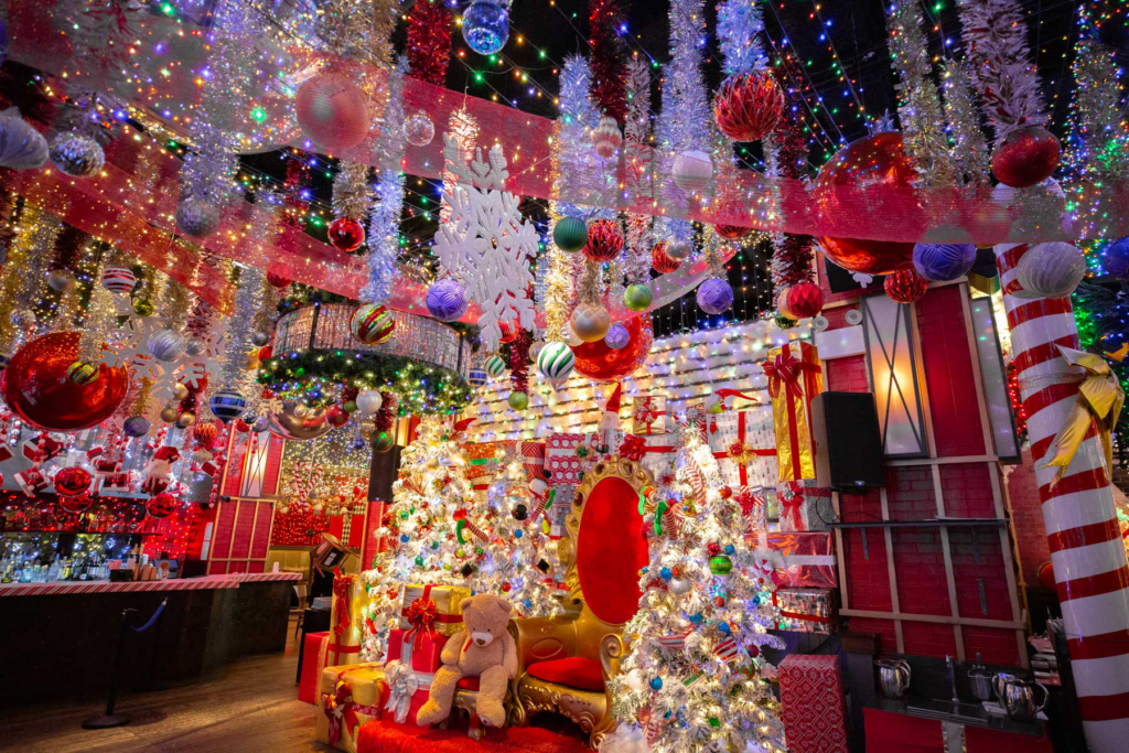 Colourful red, white, and other festive holiday decorations fill a room.