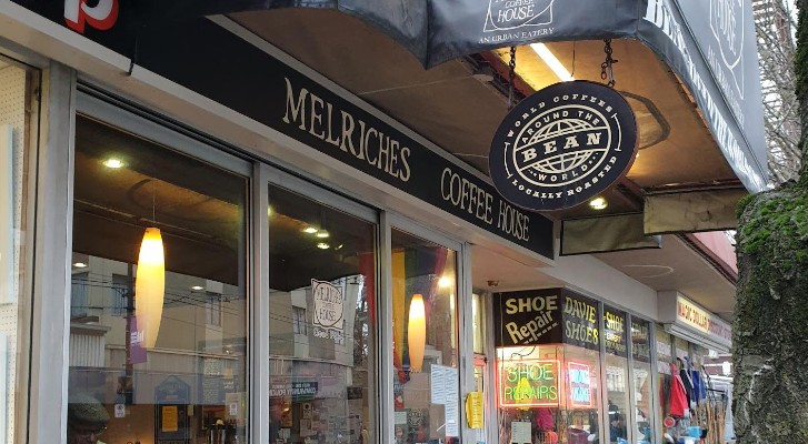 The outside of Melriches Coffee. You can see the window and the sign that says Melriches