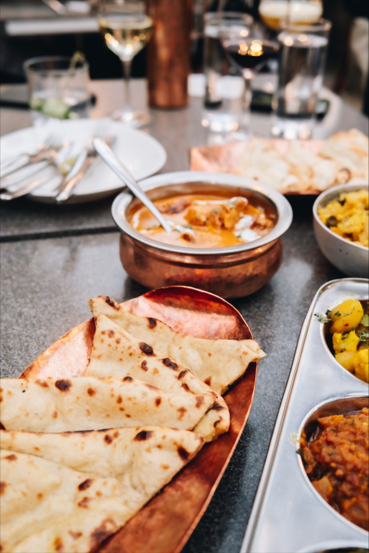 a close up shot of indian food on a table