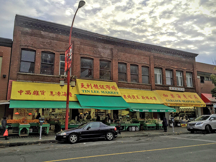 exterior of building in chinatown with Tin Lee Market written on a yellow awning