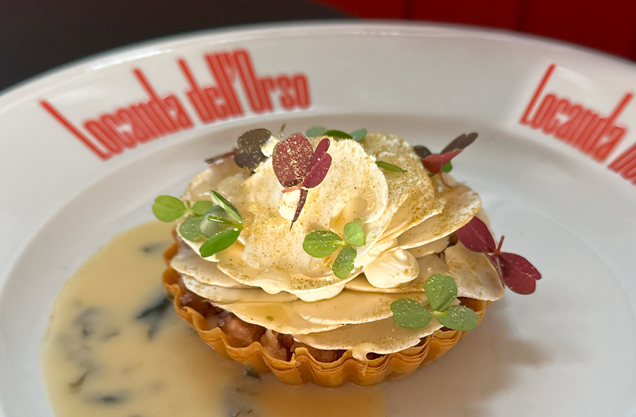 A fancy mushroom tart on a white plate.