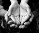 Young hands nestled in old hands.